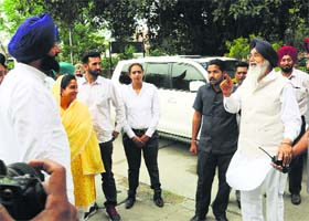Making a point: Chief Minister Parkash SIngh Badal has a word with Revenue Minister Bikramjit Singh Majithia as his sister Harsimrat Kaur Badal looks on in Bathinda on Monday