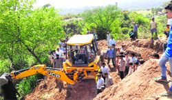 An earth mover at work to widen the tunnel near Kauna village. A Tribune photograph