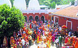 Devotees perform a puja at the Mahamaya temple on Tuesday