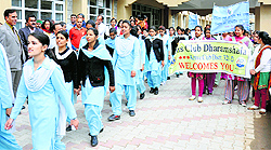 Volunteers take part in a voter awareness rally in Dharamsala on Monday