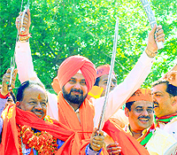 BJP Amritsar MP Navjot Singh Sidhu at a road show in support of Chandni Chowk candidate Harsh Vardhan on Tuesday