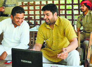 Independent candidate Navpreet Singh Bedi (right) discusses his poll strategy with a friend in Ludhiana.