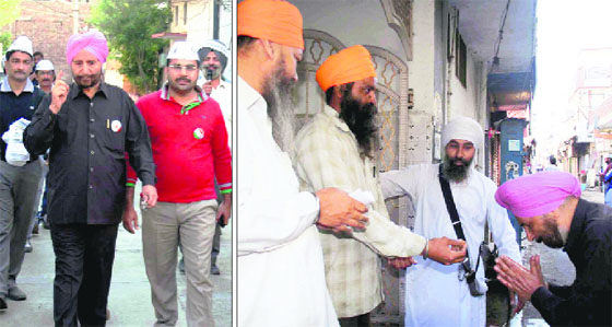 Aam Aadmi Party candidate Dr Daljit Singh interacts with local residents during a pad yatra in Amritsar on Wednesday.