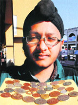 Malkeet Singh displays his coins  in Amritsar. 
