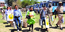 Poll staff carry EVMs and other election material to a polling booth in Sector 26, Chandigarh, on Wednesday
