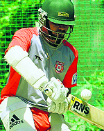 Cheteshwar Pujara and (left) Murali Karthik of Kings XI Punjab practise during a training session at the PCA Stadium, Phase IX, Mohali