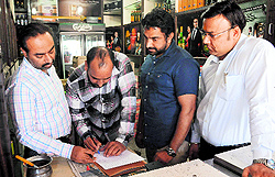Excise officials at a liquor vend in Sector 34, Chandigarh, during a raid on Wednesday