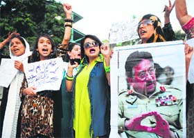Supporters of former Pakistan military ruler General Pervez Musharraf raise slogans in Karachi