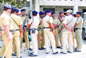 Policemen deployed at a polling booth in Gurgaon on Wednesday
