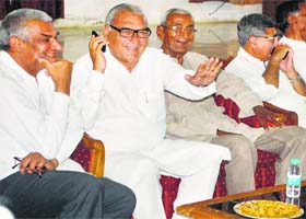 Chief Minister Bhupinder Singh Hooda shares a light moment with his friends in Rohtak on Wednesday