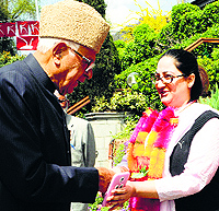 National Conference party patron and candidate from Srinagar constituency Farooq Abdullah welcomes a woman to the party fold at his residence in Srinagar on Wednesday