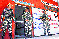 Security personnel outside a polling booth in Jammu on Wednesday