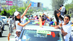 Students of the PCTE hang out of their vehicles during an election awareness rally in Ludhiana on Wednesday. Tribune photo: Himanshu Mahajan