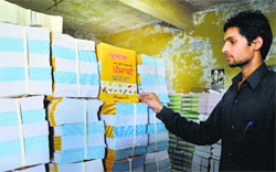 An employee of the PSEB inspects a stock of books. Photo: Inderjeet Verma 