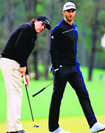Phil Mickelson putts as Dustin Johnson looks on during a practice round prior to the start of the Masters in Augusta on Tuesday. AFP