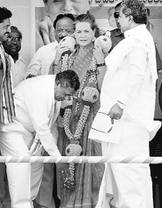 Congress candidate KH Muniyappa seeks blessings of party president Sonia Gandhi at a rally in Kolar, near Bengaluru, on Wednesday. Karnataka CM Siddharamaiah is also seen.