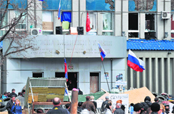People gather outside the regional security service building taken by pro-Russian activists in Lugansk on Wednesday. AFP