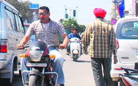 Putting traffic norms at stake, two-wheeler riders take a wrong side on the busy road with no checks from the Police Department in Amritsar