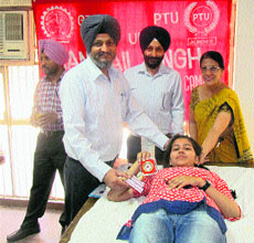 A student donates blood at a camp held on the PTU campus on Thursday.