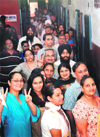 Residents wait for their turn at a polling booth in Sector 35