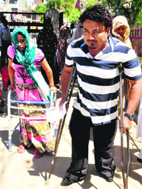 Brij Mohan and his wife Poonam Rani head for a polling booth to cast their vote in Karsan, Ram Darbar, on Thursday. 