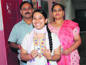 Sanjeev Rishi with his family after casting their vote on Thursday.