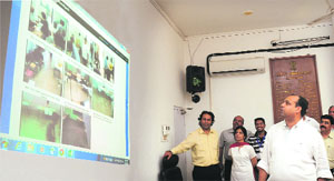 Deputy Commissioner-cum-Returning Officer Mohammed Shayin (extreme right) watches the webcast from various polling stations, at his office in Sector 17.