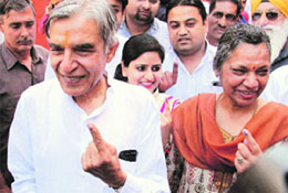 Congress candidate Pawan Kumar Bansal and his wife Madhu Bansal come out of a polling booth. 