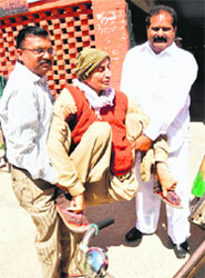 Bhagat Singh being helped to a polling booth.
