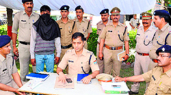 SSP Sadanand Date with an accused in the twin firing case at Ranipur police station on Thursday