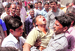 A shopkeeper breaks down after his shop was demolished by the district administration team during an anti-encroachment drive on Chakrata Road in Dehradun on Thursday