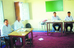 Officials on poll duty wait for electors at a polling booth in Kosli in Rewari district on Thursday. Photo by writer