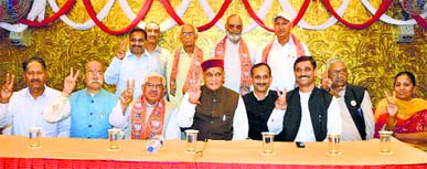 Former minister Vijay Joshi with Prem Kumar Dhumal and Satpal Satti after joining the BJP in Una on Thursday.