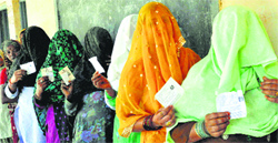 Women wait to cast votes for Lok Sabha elections in Faridabad on Thursday. PTI 