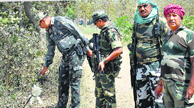 Security personnel comb the area after two crude bombs were recovered in Gaya district of Bihar on Thursday. PTI