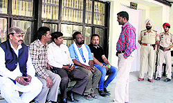 Candidates/nominees await the outcome of the scrutiny of nomination papers outside the DC office in Jalandhar on Thursday