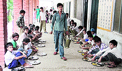 Schoolchildren being served mid-day meal in Jalandhar