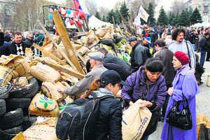 Pro-Russian protesters reinforce their barricade outside the regional state building in Donetsk on Thursday.