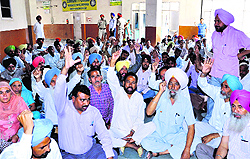 Members of the Punjab and UT Action Committee shout slogans demanding the release of their salaries at the District Administrative Complex in Bathinda on Friday