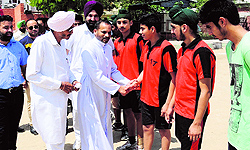 Father Eulalio Fernandes, principal of St Xaviers School, greets handball players during the Soudeep Singh Memorial Tournament in Bathinda on Friday