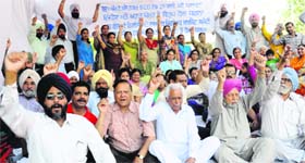 Residents protest against a liquor vend at the Phase 1 market in Mohali on Friday.