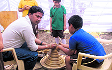 Students learn from a master craftsman during the crafts festival organised by Spicmacay in Dehradun on Friday