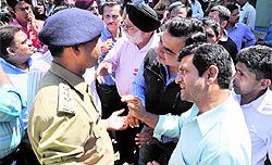 Shopkeepers protest against demolition of their shops during an anti-encrochment drive on Rajpur Road in Dehradun on Friday