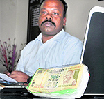 SSP, STF, Senthil Krishna Raj, shows fake currency during a press conference in Dehradun on Friday