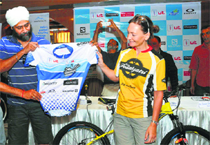 Alison Clew, a cycling athlete from the UK, releases a jersey at the press conference of the Shimla edition of MTB Himalaya on Friday