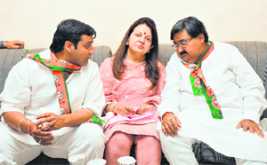 BJP-HJC nominee Ashwini Kumar Chopra with his wife Kiran and son Aditya in Karnal on Friday. 