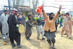 National Conference supporters dance during the roadshow of partys senior leader Mehboob Beg at Kulgam in south Kashmir on Friday.
