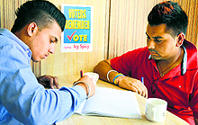 A youngster signs a pledge to vote to avail himself of a discount at a restaurant in Ludhiana