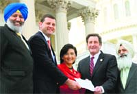 (From left) Harpreet Sandhu, Congressman Valadao, Congresswoman Chu, Congressman Garamendi and Pritpal Singh hold a copy of the resolution outside the US Capitol. Tribune photo