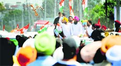 Congress candidate Ravneet Singh Bittu (in yellow turban) during a road show in Ludhiana. Tribune photo